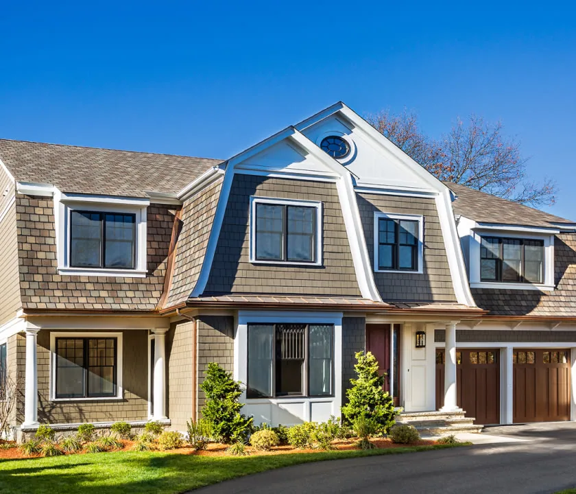 Dutch Colonial home with James Hardie HardieShingle upper and HardiePlank lap siding lower