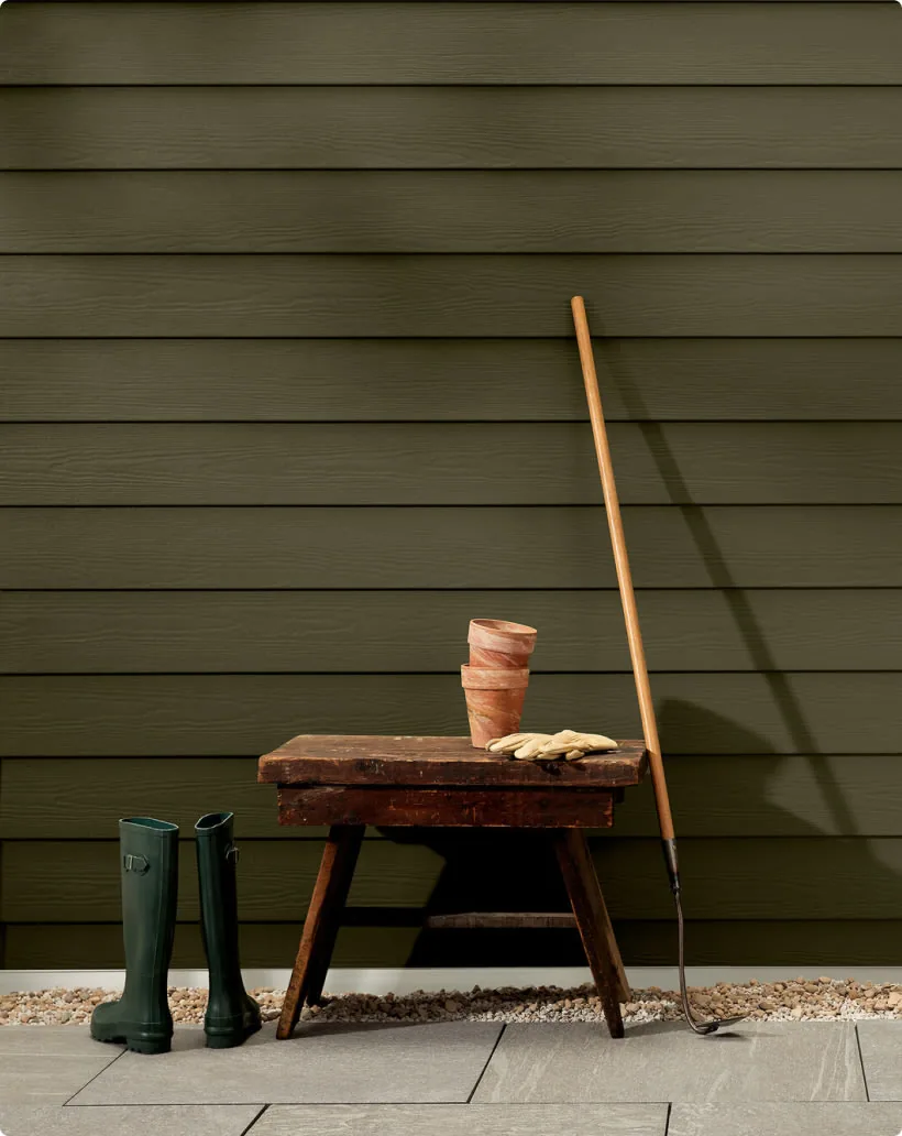 HardiePlank Select Cedarmill lap siding with horizontal cedar-grain texture in deep olive ColorPlus color
