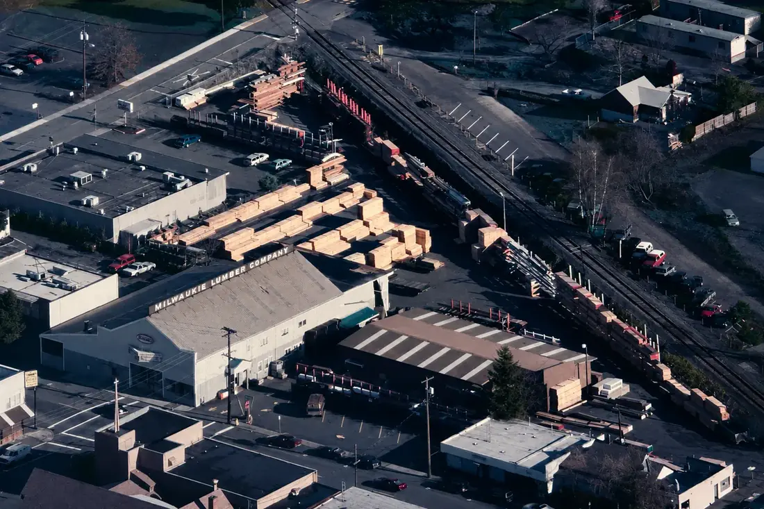 Milwaukie Lumber — aerial view of the Milwaukie Lumber Company warehouse, yard, and lumber inventory along the rail line