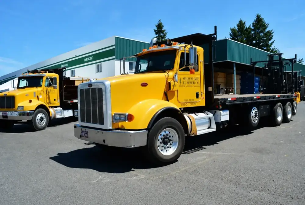 Milwaukie Lumber Co. yellow Peterbilt flatbed delivery truck