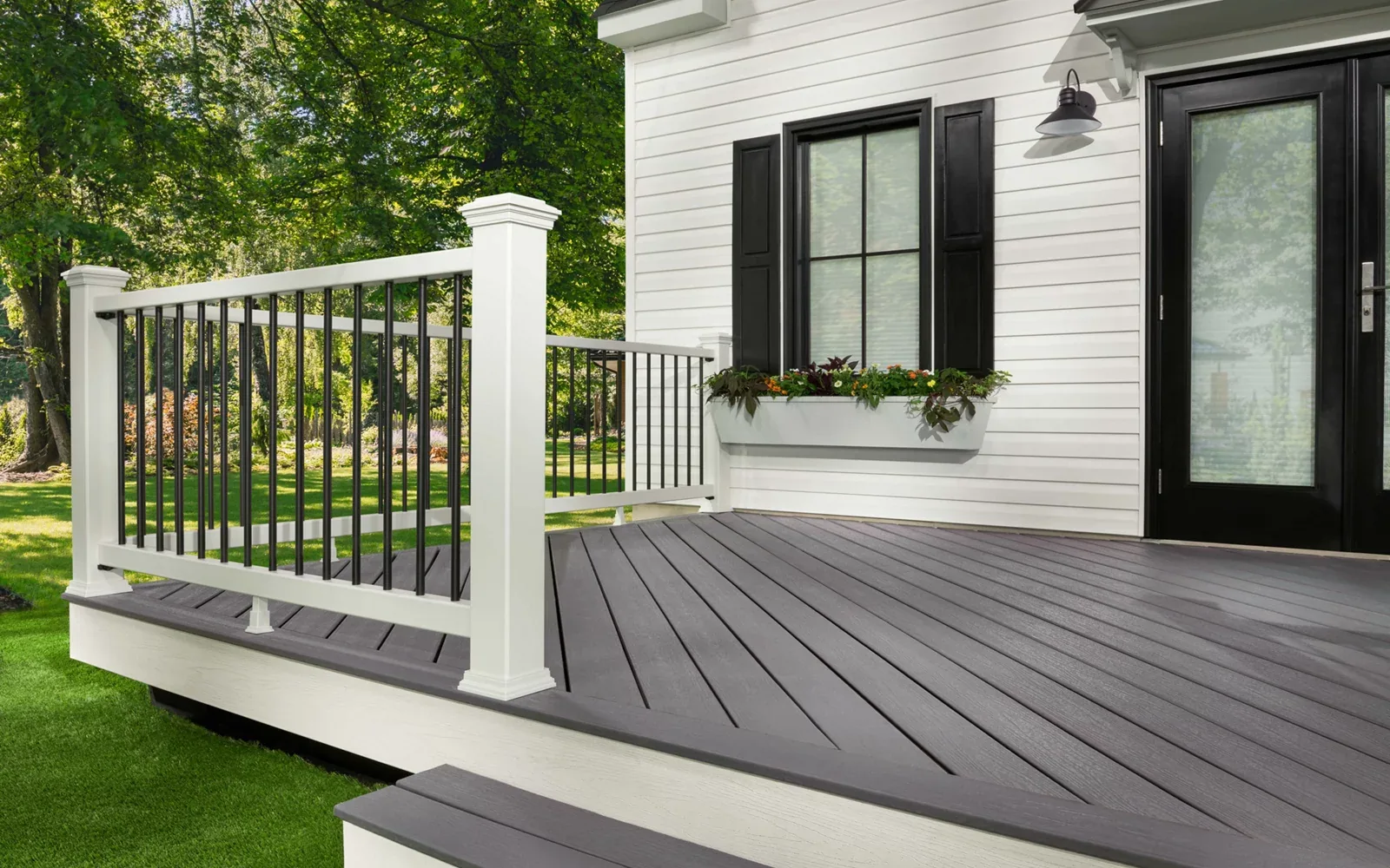Trex Enhance Basics composite deck in Pebble Beach with white railing